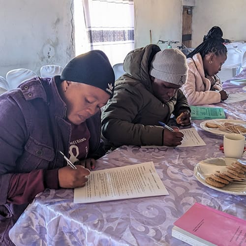 Education department at Hope International Missions Students writing on paper